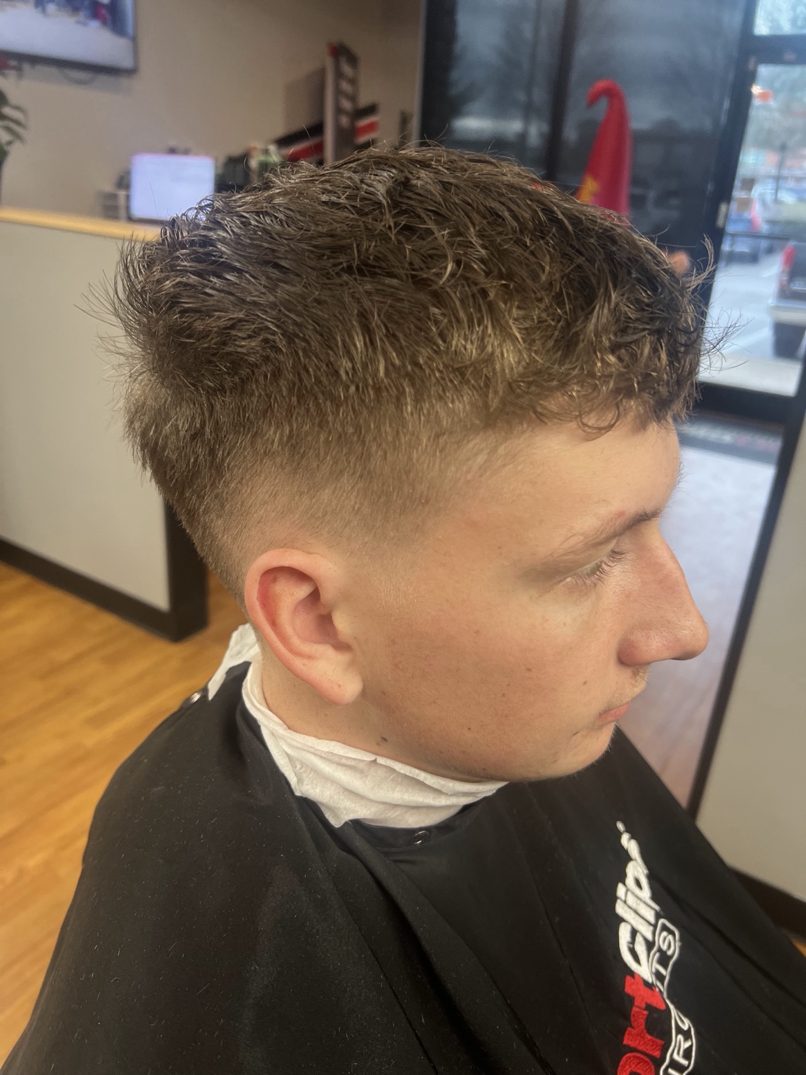 Real client wearing a clean textured taper haircut