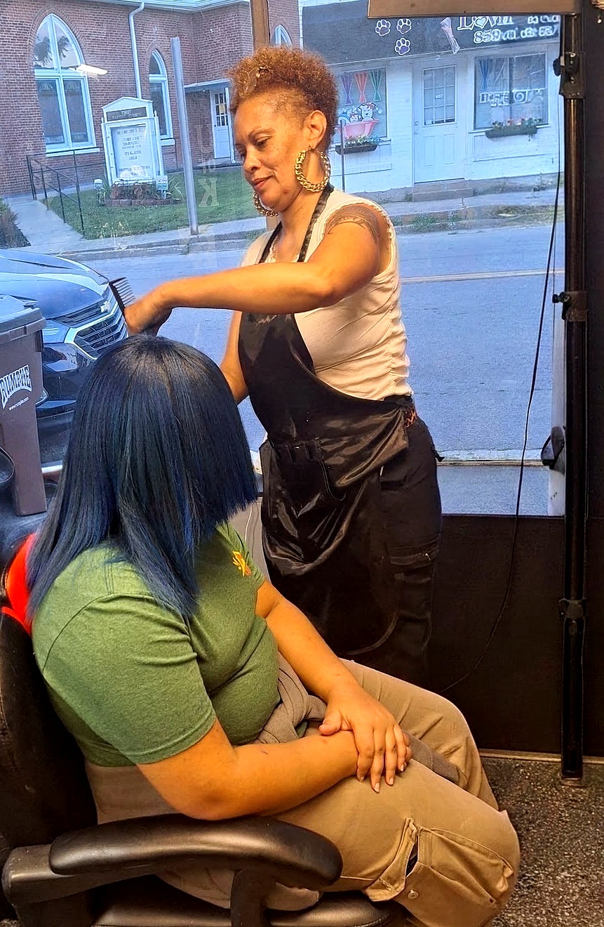 Yolanda styling a client in the salon